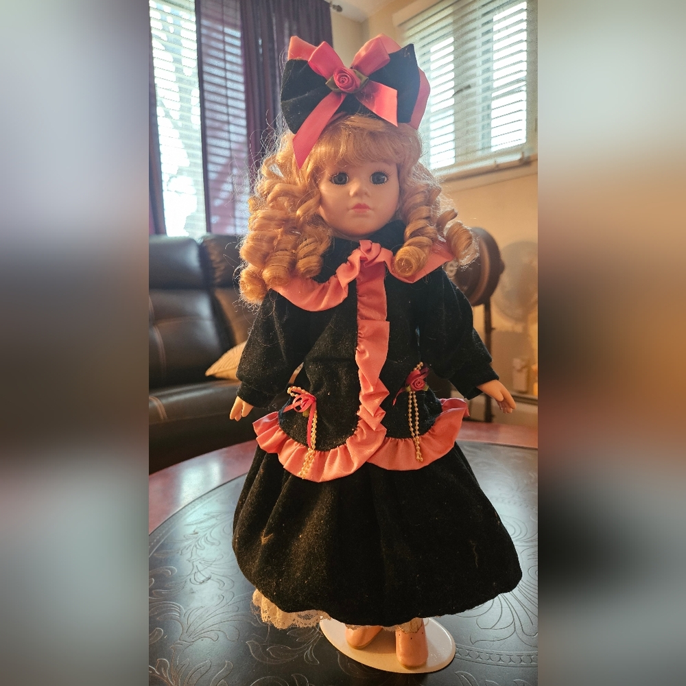 Beautiful blonde girl dressed in blue & pink Victorian fashion. She is 18" tall.